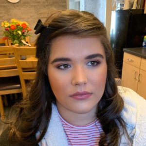 Client taking an after picture of their flawless makeup look – Expertly applied by KT Beauty for a perfect, long-lasting finish.